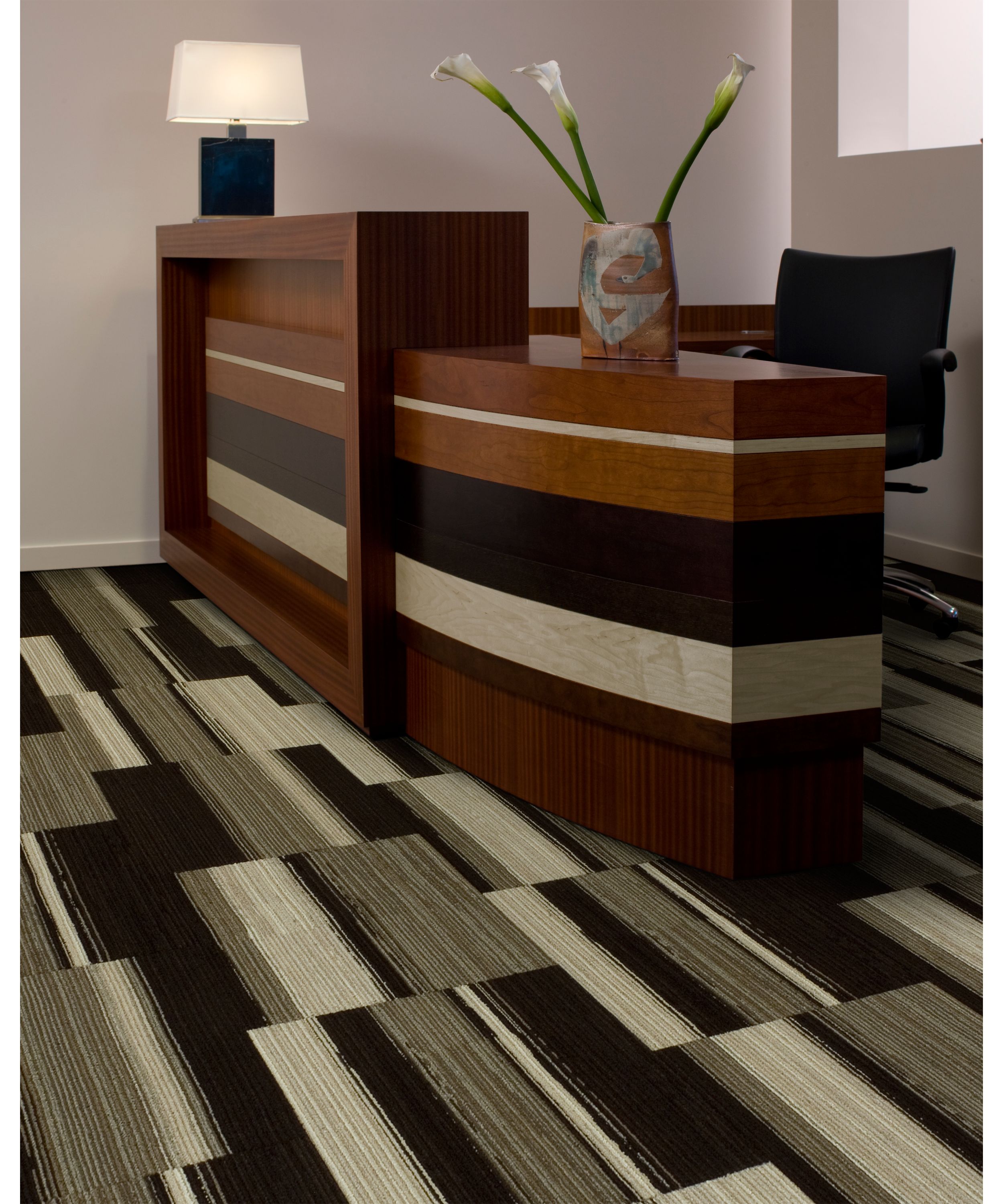 Interface Across the Board carpet tile in reception area with wood desk and Calla lillies image number 1